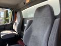 Interior of a 2015 Freightliner M2 106 featuring two gray fabric seats with simple designs and seatbelts