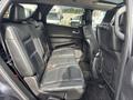 Interior view of a 2015 Dodge Durango showcasing black leather seating with two rows of seats and a modern design.
