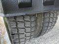 The image shows the tire of a 2009 Ford LCF 550 with a detailed tread pattern visible on the surface and part of the chassis above the tire