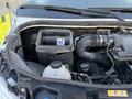 The engine compartment of a 2020 Mercedes-Benz Sprinter showing various components including a container labeled with a no symbol and a black air intake hose