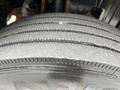 Close-up of a treaded tire from a 2008 Mitsubishi Fuso FE180 showing distinct grooves and a smooth surface