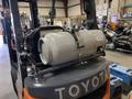 A 2021 Toyota Fork Lift displaying a cylindrical gas tank secured on its back with a metal bracket
