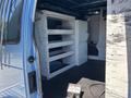 A 2008 Ford E-350 interior featuring organized shelving units and equipment storage on one side