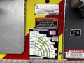 A close-up of a control panel on a 2009 Spartan Gladiator fire truck featuring warning labels and load capacity charts for a ladder system