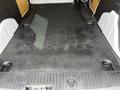 Interior cargo space of a 2016 Ford Transit Connect with a flat black floor and multiple anchor points for securing cargo