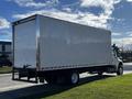 A white 2016 Freightliner M2 106 box truck parked on the street with a clean design and large cargo area