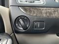 Close-up of a Dodge Grand Caravan's interior controls including headlight switch and dashboard light dimmer