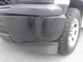 A 2015 Chevrolet Silverado 1500 with a damaged front bumper and tire showing signs of wear