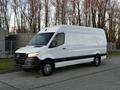 A white 2019 Mercedes-Benz Sprinter van with a high roof and black accents parked on a street