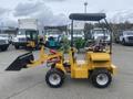 A yellow 2024 AGT KRW 23 Mini loader with a front bucket and compact design featuring four wheels and a covered operator's seat