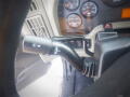 Close-up of the gear shift lever in a 2016 International WorkStar 7500 featuring a simple design with various gear indications and control buttons