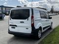 A 2016 Ford Transit Connect van in white parked with a rear view showing a clean design and standard wheels