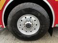 A close-up of the wheel of a 2009 Spartan Gladiator featuring a silver rim with multiple bolts and a large black tire marked with Michelin branding