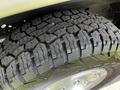 Close-up of a treaded tire on a 2004 Ford Econoline showing detailed patterns and grooves for traction