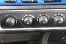 Dashboard controls of a 2015 Kenworth T660 featuring four dials for adjusting temperature and airflow settings