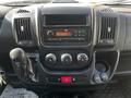 Dashboard of a 2017 RAM Promaster featuring a radio, climate controls, and gear shift with various buttons and dials