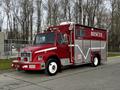 A red 1994 Freightliner FL80 fire rescue truck featuring the word RESCUE on its side with emergency lights and equipment visible on the chassis