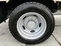 Close-up of a wheel and tire from a 2007 Ford F-550 featuring a silver rim and treaded black tire