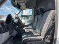 Interior of a 2010 Mercedes-Benz Sprinter featuring a driver’s seat and two passenger seats all with black fabric upholstery