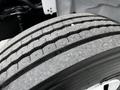 Close-up of a tire tread on a 2020 Hino 338 showing prominent grooves and a textured surface designed for traction and stability