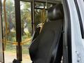 A 2020 Chevrolet Express driver's seat with a black fabric cover positioned in an interior setting