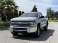 A silver 2016 Chevrolet Silverado 2500HD pickup truck with chrome front grille and headlights facing forward