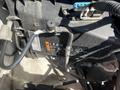 A 2013 Chevrolet Express vehicle engine compartment with visible components including a black box and connected tubes