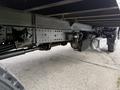 The underside view of a 2018 Hino 195 featuring the chassis axle and suspension components with exposed mechanics and a visible exhaust pipe