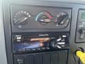 Dashboard controls of a 2007 International 7300 featuring climate control knobs and a Delphi Bluetooth radio with various buttons and a digital display