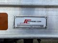 A metal nameplate on a vehicle displaying the text manufactured by Supreme Corp and a serial number