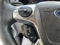 Close-up of the steering wheel of a 2015 Ford Transit showing various controls including the OK button and cruise control settings