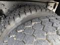 Close-up of the tread on a large tire from a 2016 International 7600 showing deep grooves and rugged surface designed for traction