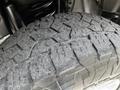 Close-up of a heavily treaded tire from a 2020 Ford F-350 Super Duty showcasing its rugged design and grip suitable for off-road conditions