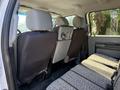 Interior of a 2012 Ford F-350 SD showing the rear seats with two headrests and a bench seat covered in patterned fabric