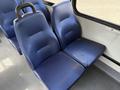 Two blue upholstered seats with a textured surface in a vehicle interior