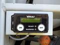A control panel with buttons labeled ON and OFF and a display screen showing the status of a VMAC system