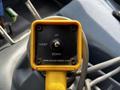 A yellow hoist control panel with buttons labeled UP and DOWN