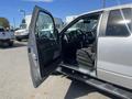 A 2014 Ford F-150 with an open driver's side door showcasing the interior and dashboard