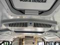 The interior ceiling of a 2018 Chevrolet Express with a ventilation system and emergency exit signage visible