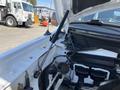 A 2014 Ford F-150 with an open hood revealing the engine compartment and components inside