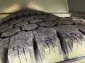 Close-up of a heavily worn tire tread on a 2017 Chevrolet Express with visible grooves and wear patterns