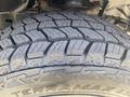 Close-up of a tire with deep treads mounted on a 2021 RAM 1500 showcasing the rugged design suitable for off-road driving