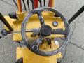 A close-up view of the steering wheel of a 2024 AGT KRW 23 Mini loader with protective wrapping still on the wheel and control panel visible