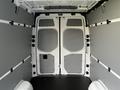 The image shows the interior of a 2022 Mercedes-Benz Sprinter with gray walls and open double doors at the back