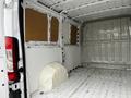 Interior of a 2018 RAM Promaster showing bare metal walls and a clean cargo area with a partially covered wheel well