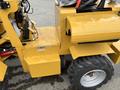 Close-up of a yellow 2024 AGT Industrial KRW23 Mini Loader showing its engine bay and wheel with hydraulic components visible