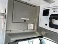 Interior dashboard view of a 2017 Chevrolet Express featuring a gray overhead console with storage compartment and speaker mounted on the wall