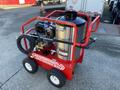 A red 2024 Magnum 4000 Hot Water Pressure Washer with a large black water tank and wheels for mobility featuring various hoses and controls on the side