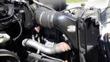 Close-up of the engine components of a 2006 Ford F-650 showing the air intake and attached hoses