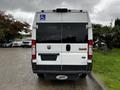 A 2016 RAM Promaster van with a wheelchair accessibility sign on the back and a blank license plate holder